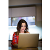 Pretty, mid-aged woman having a virtual Wine Tasting Dinner Event Online Using Laptop with friends