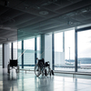 Wheelchairs in a modern airport. Wheelchairs ready for use by passangers with disabilities