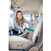 Pretty, middle aged woman vacuum cleaning the interior of a luxury car