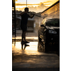 Young man washing his beloved car carefully in a manual car wash to prevent any damage and detail it properly