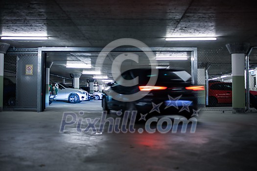 Underground parking. Cars parked in a garage with no people. Many cars in parking garage interior. Underground parking with cars (color toned image) Underground parking. Cars parked in a garage with no people. Many cars in parking garage interior. Underground parking with cars (color toned image)