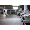 Underground parking. Cars parked in a garage with no people. Many cars in parking garage interior. Underground parking with cars (color toned image)