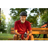 Senior man with his mountain bike going for a ride past the city limits in a lovely forest, getting the daily cardio dose, having a break on a bench