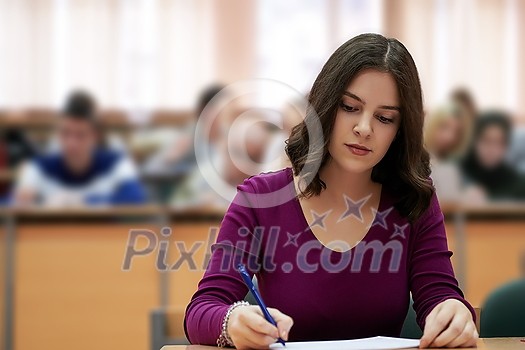 portrait of a beautiful girl sitting in an amphitheater and talking to her colleagues while attending classes portrait of a beautiful girl sitting in an amphitheater and talking to her colleagues while attending classes