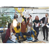 Group of business people having party and  throwing paper in air at modern coworking open space  startup office