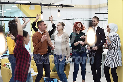 Group of business people having party and throwing paper in air at modern coworking open space startup office Group of business people having party and throwing paper in air at modern coworking open space startup office
