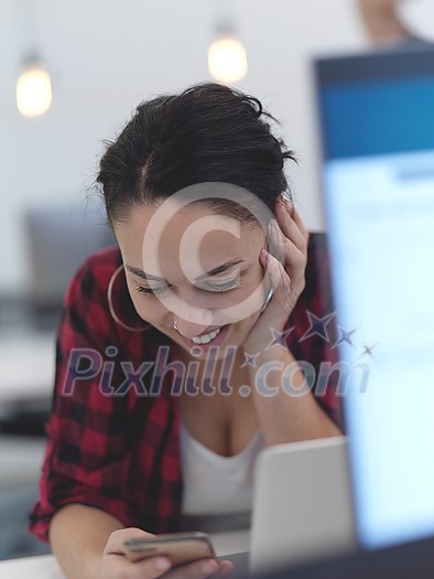business woman portrait in open space startup coworking office as influencer using smart phone, tablet computer business woman portrait in open space startup coworking office as influencer using smart phone, tablet computer