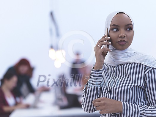 african muslim businesswoman using smart phone wearing hijab at creative modern startup coworking open space office african muslim businesswoman using smart phone wearing hijab at creative modern startup coworking open space office