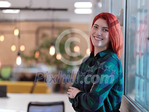 redhead business woman portrait as influencer in creative modern coworking startup open space office