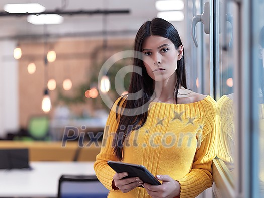 business woman portrait in open space startup coworking office as influencer using smart phone, tablet computer business woman portrait in open space startup coworking office as influencer using smart phone, tablet computer