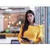 business woman portrait  in open space startup coworking office as influencer  using smart phone, tablet computer