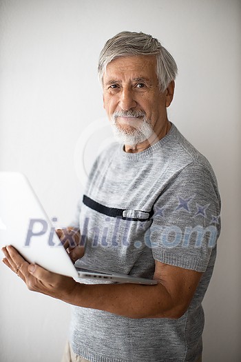 Senior man with a modern laptop computer, using the computer without any issues - so typical for his generation Senior man with a modern laptop computer, using the computer without any issues - so typical for his generation