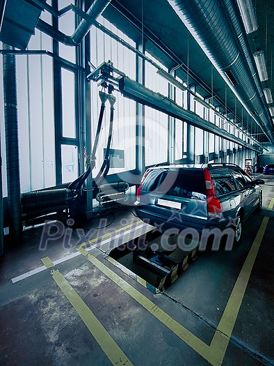 Car in a car service, garage being checked. Car service, body repair, spare parts. Car in a car service, garage being checked. Car service, body repair, spare parts.