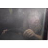 Pretty midle aged woman at the steering wheel of her car commuting to work