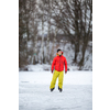 Young man ice skating outdoors on a pond on a freezing winter day