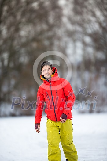 Young man ice skating outdoors on a pond on a freezing winter day Young man ice skating outdoors on a pond on a freezing winter day