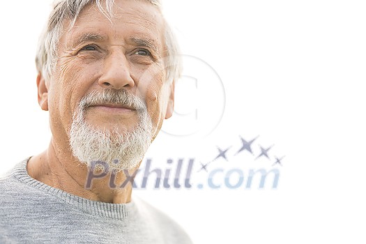 Portrait of a senior man outdoors, against the sky - optimism, good health, happyness radiates of the man's face, expression Portrait of a senior man outdoors, against the sky - optimism, good health, happyness radiates of the man's face, expression