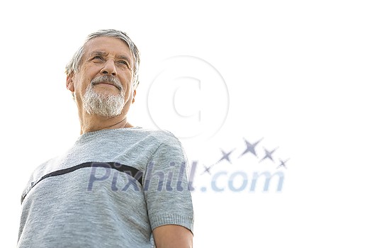 Happy senior man outdoors against the sky on a warm summer day Happy senior man outdoors against the sky on a warm summer day