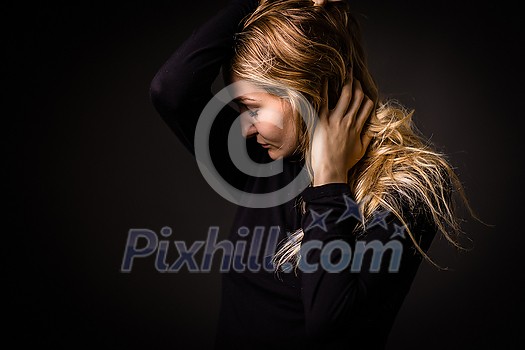 Depressed young woman at home feeling sad, lonely, anxious (color toned image) Depressed young woman at home feeling sad, lonely, anxious (color toned image)
