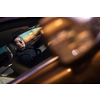 Handsome young man driving his car at night (color toned image; motion blurred image)