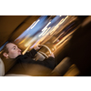 Handsome young man driving his car at night (color toned image; motion blurred image)