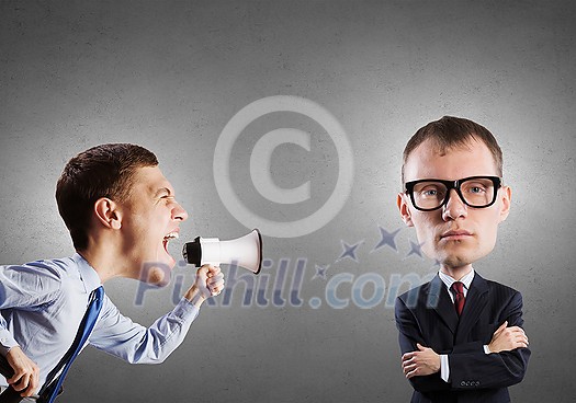 Funny young man with big head screaming emotionally in megaphone Funny young man with big head screaming emotionally in megaphone