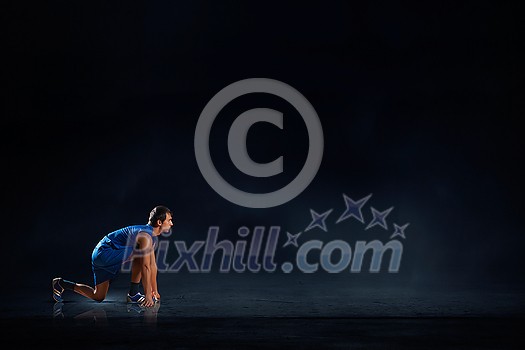 Young man athlete standing in start pose Young man athlete standing in start pose