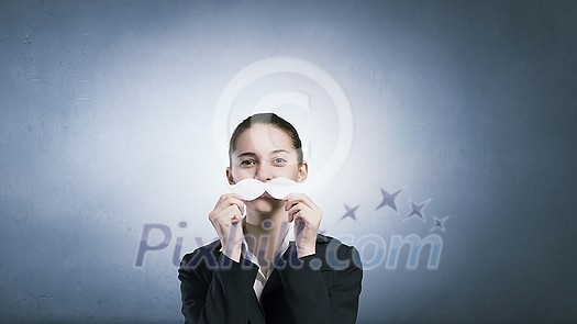 Happy cute girl trying male paper mustache Happy cute girl trying male paper mustache