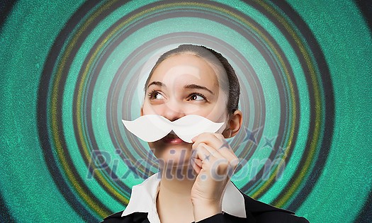 Happy cute girl trying male paper mustache Happy cute girl trying male paper mustache