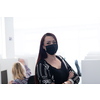 Female call center operator talking to a customer. Businesswoman in mask at the workplace in the  modern office. Social distance and safety outbreak new normal concept