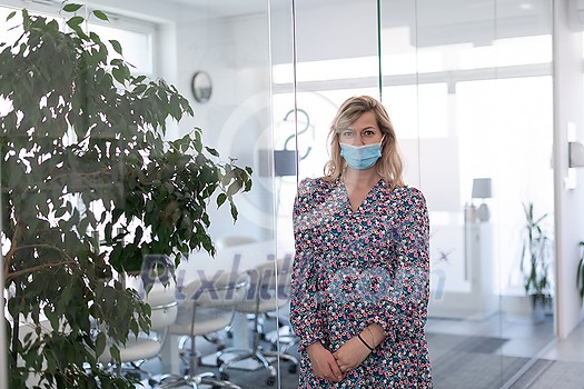 business woman portrait wearing medical mask in bright modern office new normal coronavirus outbreak concept real people business woman portrait wearing medical mask in bright modern office new normal coronavirus outbreak concept real people