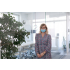 business woman portrait wearing medical mask in bright modern office new normal coronavirus outbreak concept real people