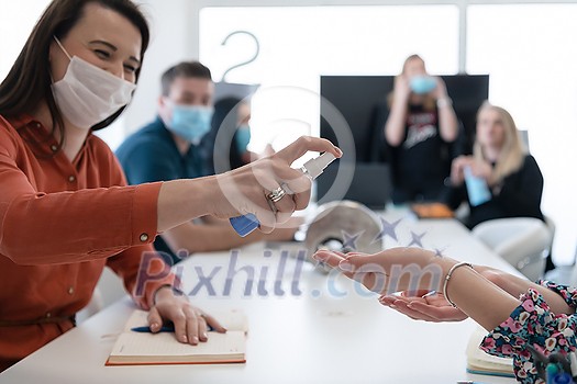 business people group on meeting using antibacterial hand sanitizer to prevent coronavirus pandemic new normal covid19 outbreak concept business people group on meeting using antibacterial hand sanitizer to prevent coronavirus pandemic new normal covid19 outbreak concept