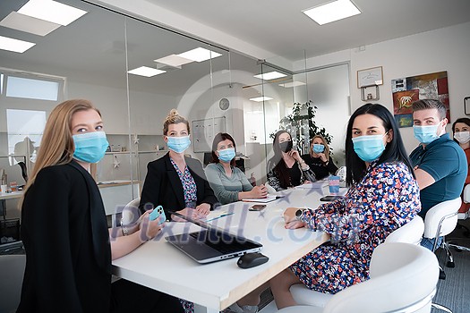 real businesspeople on business meeting in bright office on coronavirus new normal time wearing protective medical face mask and keep distance real businesspeople on business meeting in bright office on coronavirus new normal time wearing protective medical face mask and keep distance