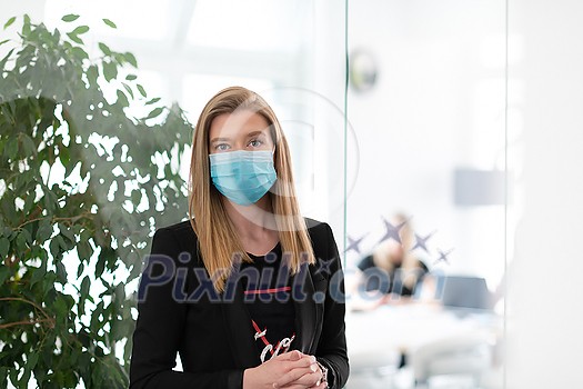 business woman portrait wearing medical mask in bright modern office new normal coronavirus outbreak concept real people business woman portrait wearing medical mask in bright modern office new normal coronavirus outbreak concept real people