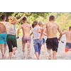 Summer joy group of happy friends having fun while running and splashing on river