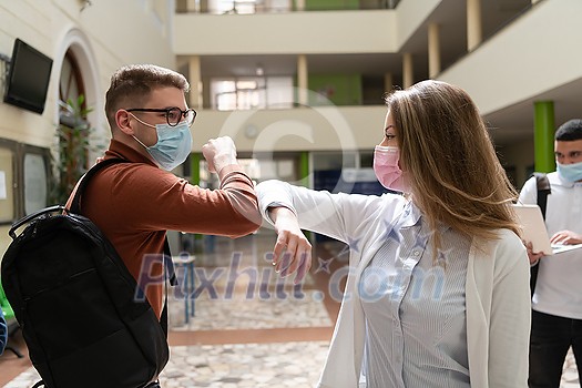 University students group greeting new normal coronavirus education lifestyle handshake and elbow bumping while wearing protective face masks University students group greeting new normal coronavirus education lifestyle handshake and elbow bumping while wearing protective face masks