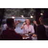group of happy friends having picnic french dinner party outdoor during summer holiday vacation near the river at beautiful nature