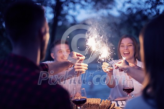 group of happy friends having picnic french dinner party outdoor during summer holiday vacation near the river at beautiful nature