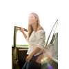 Pretty middle aged woman at the steering wheel of her car