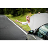 Pretty middle aged woman having car troubles - broken down car on the side of the road, calling the insurance company for assistance