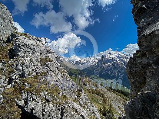 Pretty female climber on a steep Via Ferrata in the Swiss Alps - fearlessly climbing higher on this extreme alpine trail Pretty female climber on a steep Via Ferrata in the Swiss Alps - fearlessly climbing higher on this extreme alpine trail