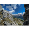 Pretty female climber on a steep Via Ferrata in the Swiss Alps - fearlessly climbing higher on this extreme alpine trail