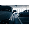 Underground parking. Cars parked in a garage with no people. Many cars in parking garage interior. Underground parking with cars (color toned image)