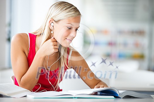 In the library - pretty female student with books working in a high school library (color toned image) In the library - pretty female student with books working in a high school library (color toned image)