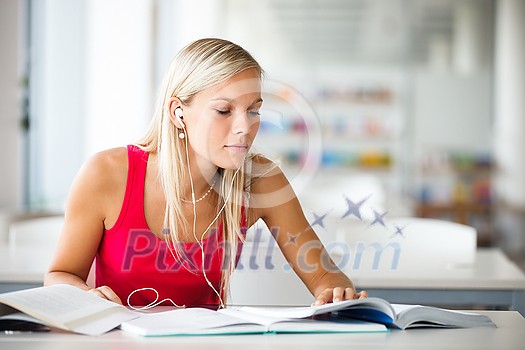 In the library - pretty female student with books working in a high school library (color toned image) In the library - pretty female student with books working in a high school library (color toned image)
