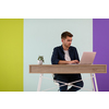 Smiling young man freelancer using laptop studying online working from home, happy casual millennial guy typing on pc notebook surfing internet 
