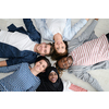 a top view of a diverse group of people lying on the floor and symbolizing togetherness
