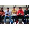 a group of students sit in the school hallway and use notebooks, tablets and cameras to create projects for the school