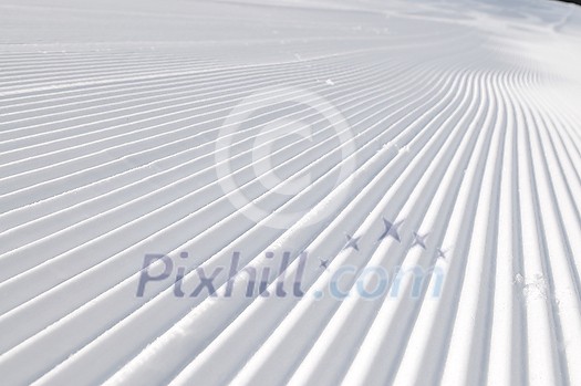 tracks on ski slopes in snow at beautiful sunny winter day with blue sky tracks on ski slopes in snow at beautiful sunny winter day with blue sky